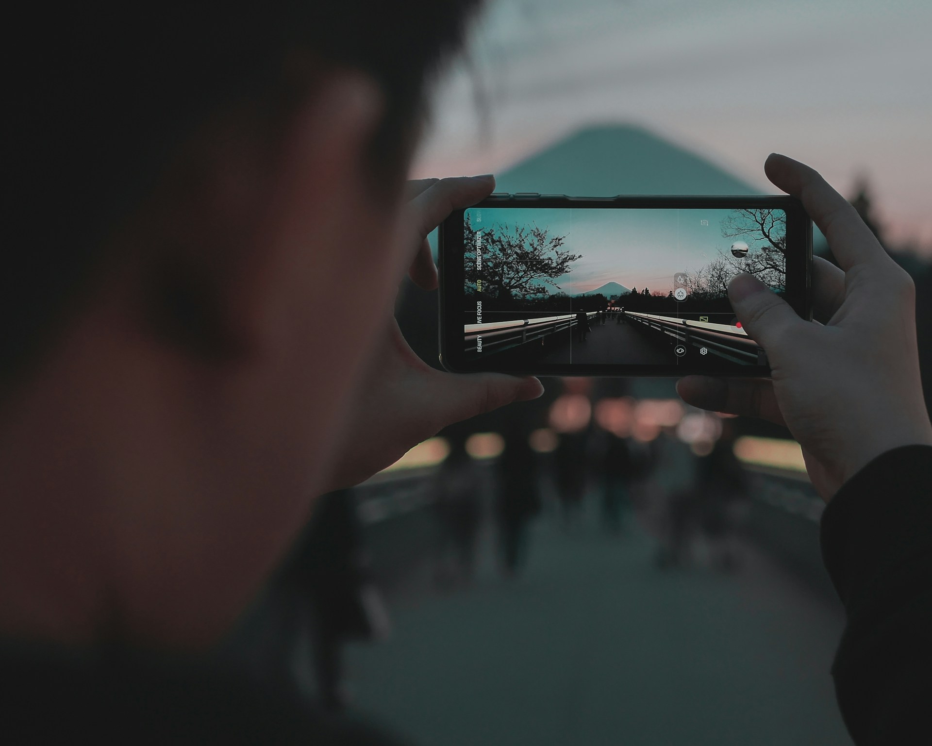 person taking a photo of the city during the daytime