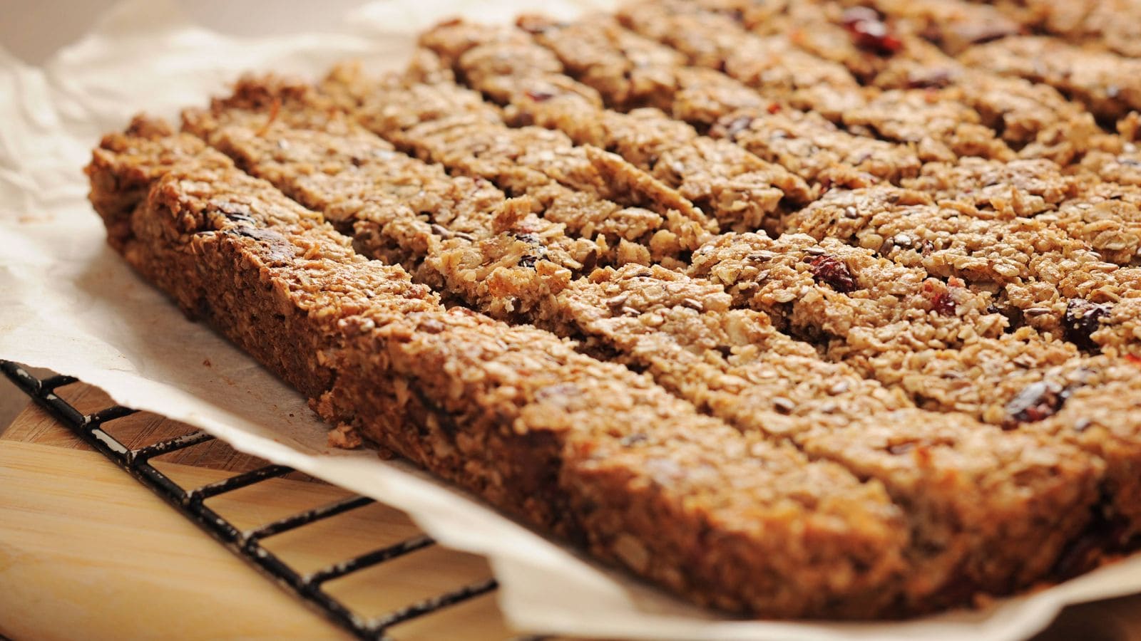 Homemade oat and cranberry bars on baking paper