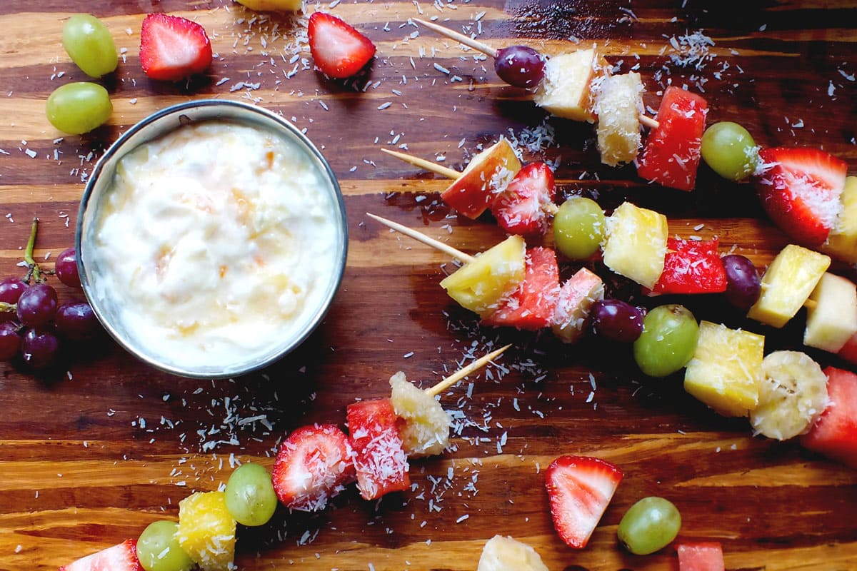 Fruit skewers with yogurt dip and coconut shredded