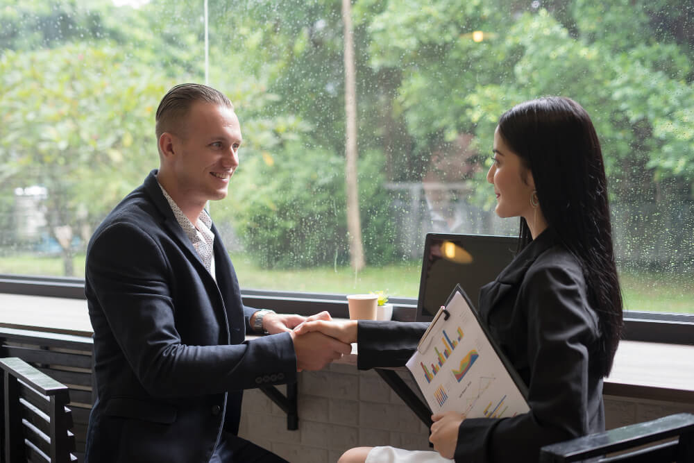 Business people shaking hands after landing the first client
